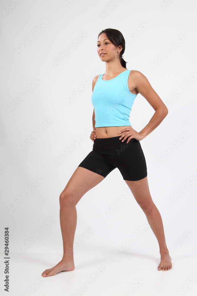 Full body shot athletic young woman stretching Full body shot athletic young woman stretching