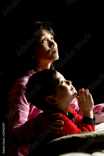 Mother and son saying prayers.