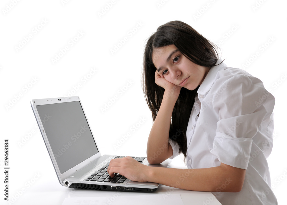 Teen girl thinking while working on computer isolated on white. Teen girl thinking while working on computer isolated on white.
