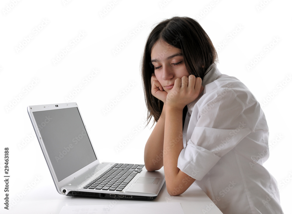 Teen girl sleeping while working on computer isolated. Teen girl sleeping while working on computer isolated.
