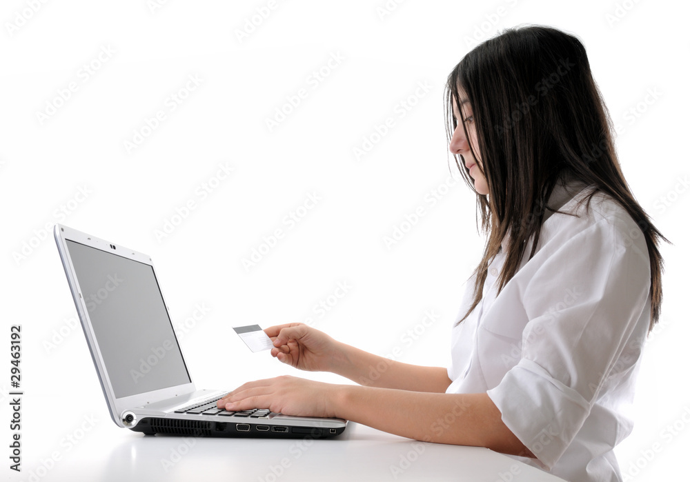 Teen girl shopping through internet using her credit card. Teen girl shopping through internet using her credit card.