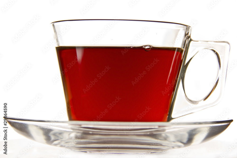 A cup of tea in a clear cup on a saucer A cup of tea in a clear cup on a saucer