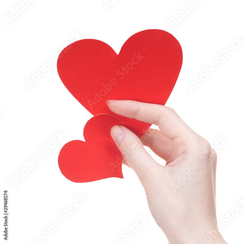 Two Valentine's day greeting card hearts in girl's hand on white