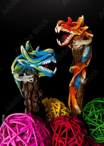 Two dragons climbing on tree isoloated on black background