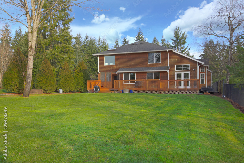 Obraz premium Large yard and a cute wood two story home