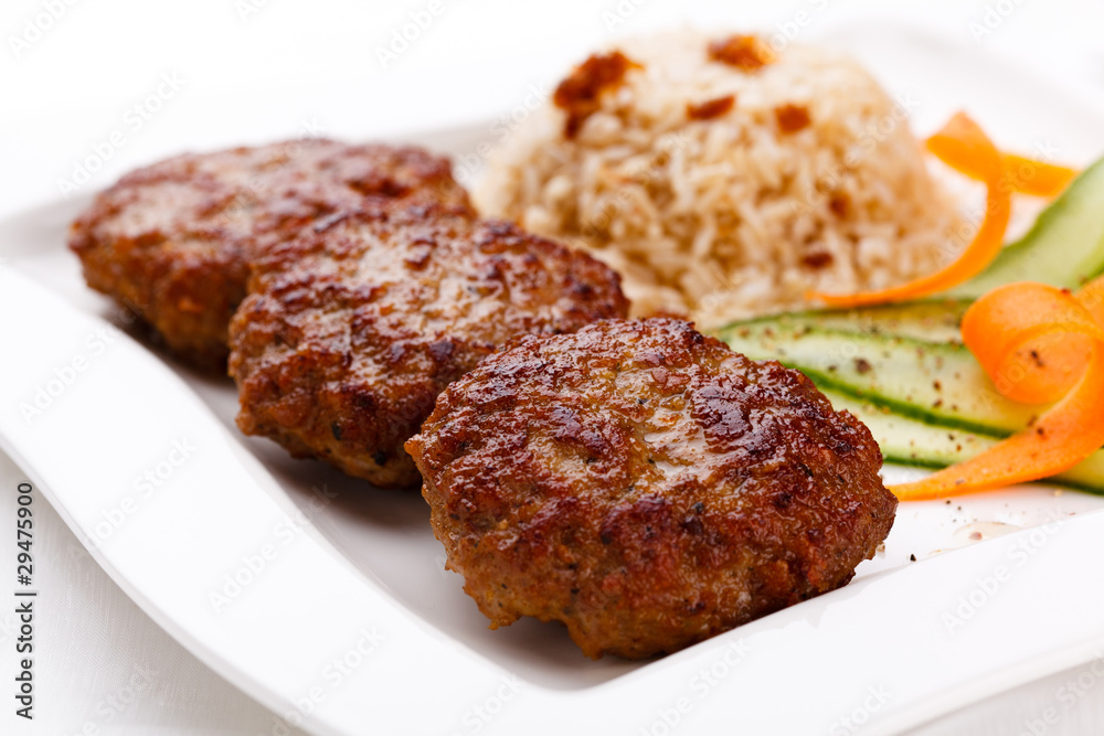 Fried steaks with rice and vegetable salad Fried steaks with rice and vegetable salad