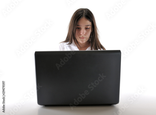 Teenager working on computer isolated on white background. © uwimages