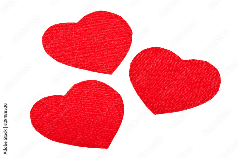 Three red textile hearts isolated