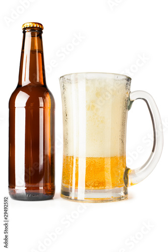 Bottle full of beer and mug with fresh beer and foam