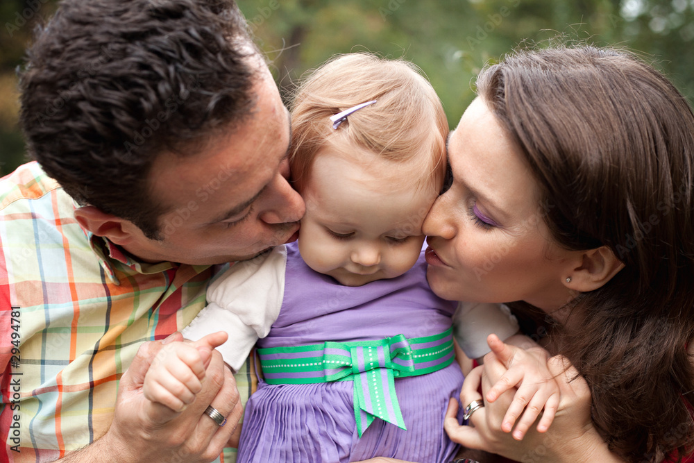 Kiss of love - parents with their baby girl Kiss of love - parents with their baby girl