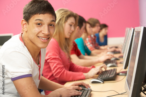 Teenage Students In IT Class Using Computers In Classroom