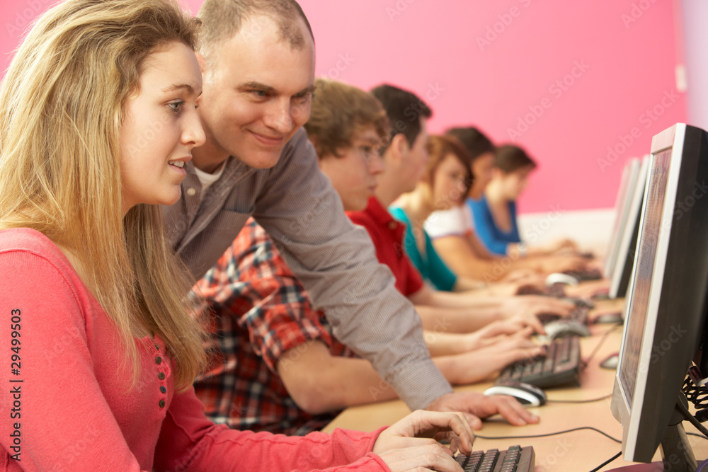 Teenage Students In IT Class Using Computers In Classroom With T Teenage Students In IT Class Using Computers In Classroom With T