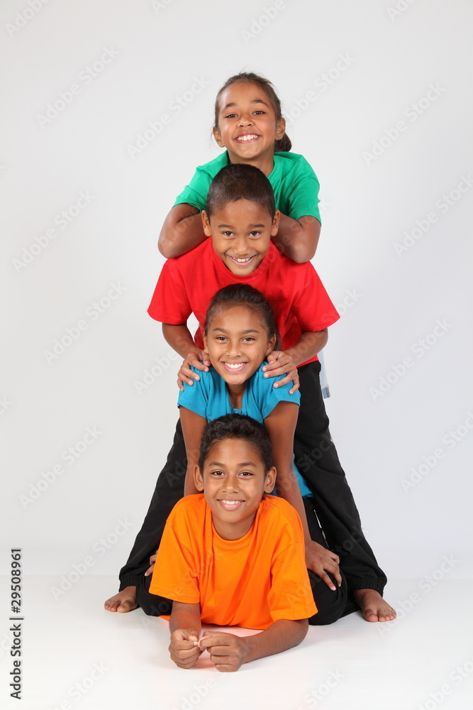 Cheerful school friends together in totem-pole stack