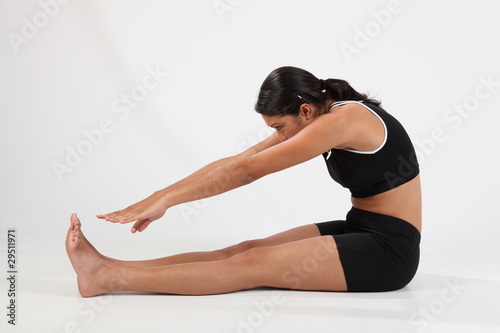Girl in hamstring stretch to touch toes