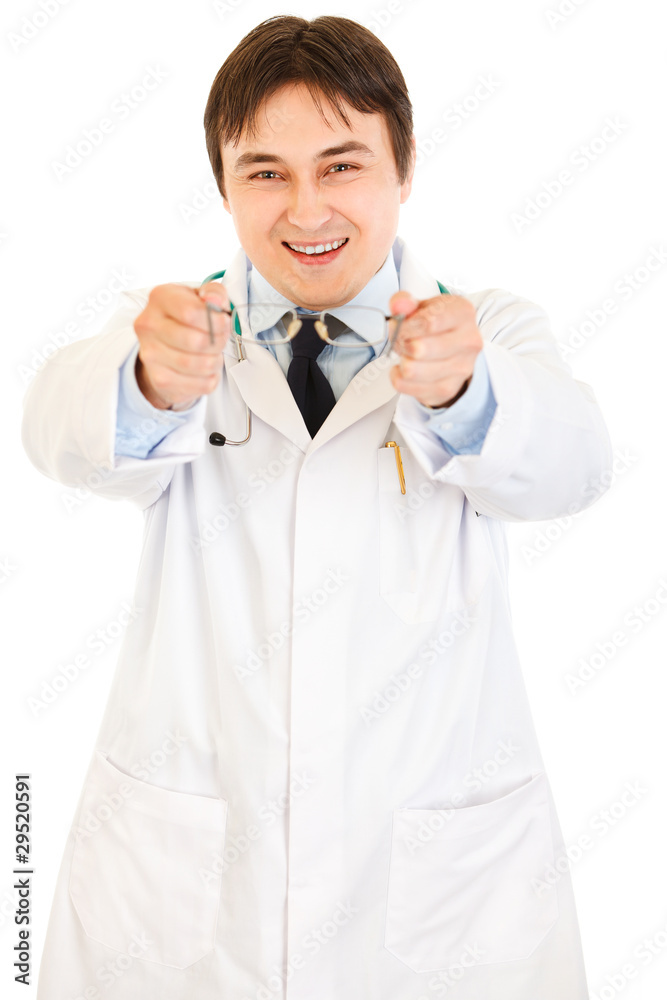 Smiling oculist giving classic-styled glasses Smiling oculist giving classic-styled glasses