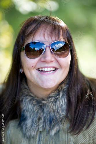 Nice young amaze brunette woman with sun glasses in the park © Alinute