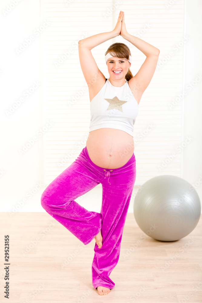 Smiling beautiful pregnant woman doing pilates exercises Smiling beautiful pregnant woman doing pilates exercises