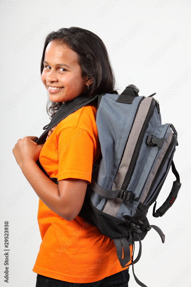 School girl looking over shoulder off to school School girl looking over shoulder off to school