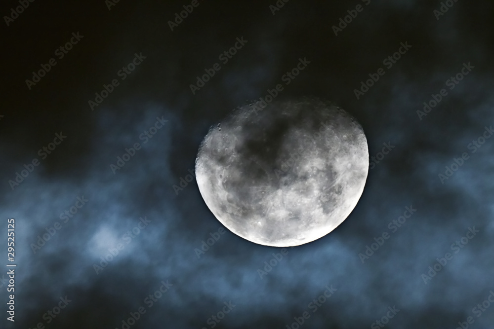 Naklejka premium Waning gibbous moon behind the clouds