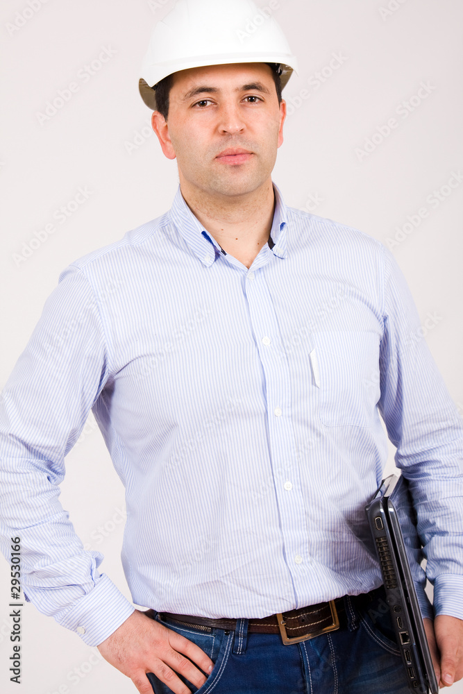 Picture of an Engineer with white hat and a laptop computer Picture of an Engineer with white hat and a laptop computer