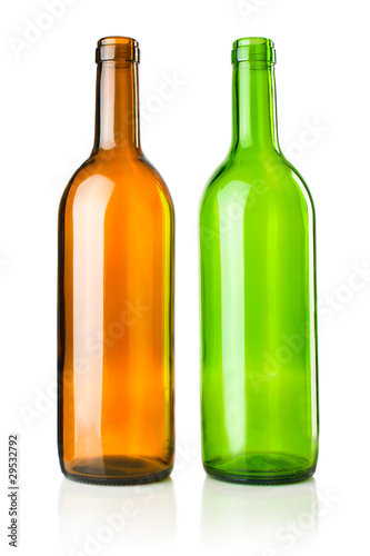 Two empty transparent green and brown wine bottles