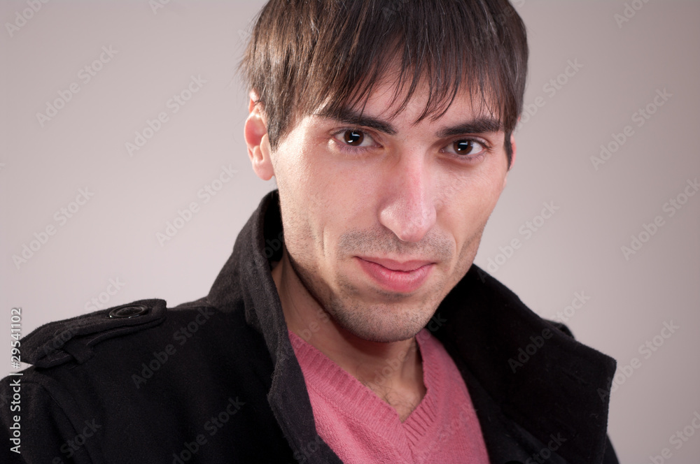Obraz premium The man in the coat mysteriously smiling