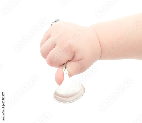 baby's hand holding a spoon