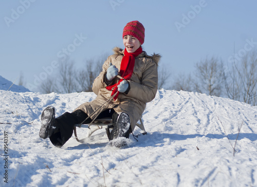 Canvastavla Teen girl sledding from a hill