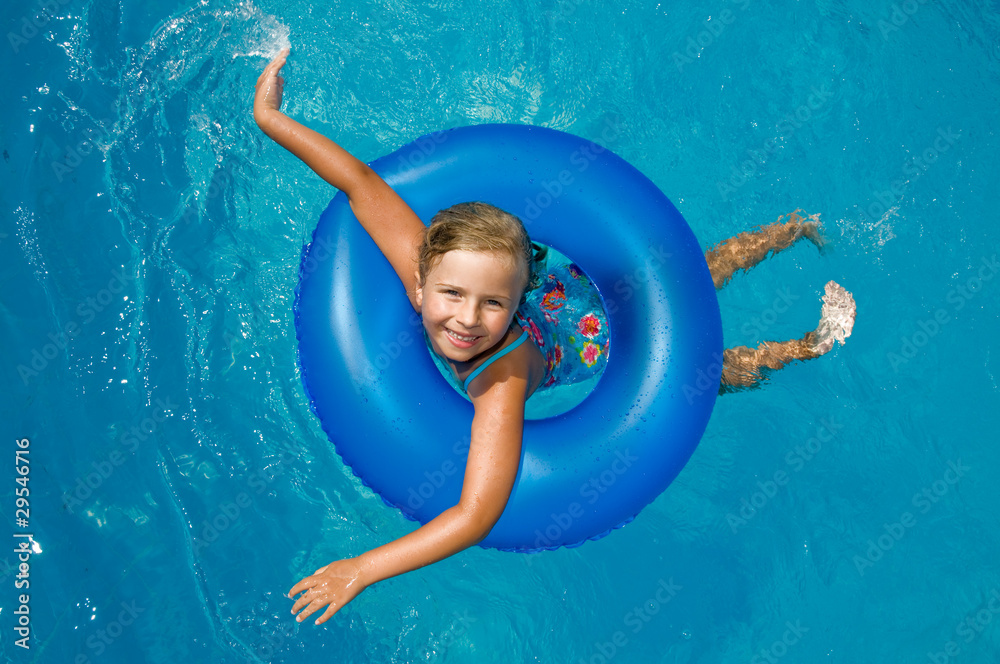 Little girl playing in blue water Stock Photo | Adobe Stock