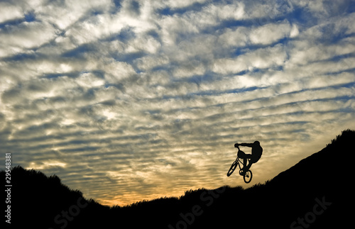 Extreme sports bike riding silhouette against stunning sunset