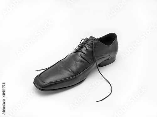 male black leather shoe against white