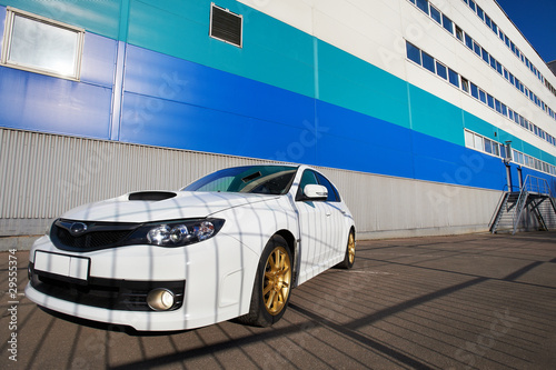 White sport car on background industrial building