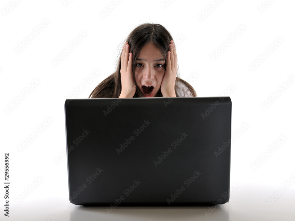 Surprised teenager working on computer isolated. Surprised teenager working on computer isolated.