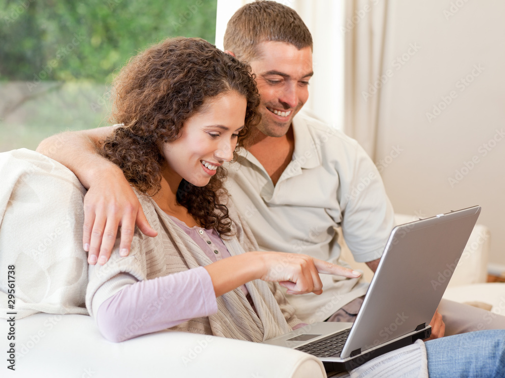 Couple working on their laptop at home Couple working on their laptop at home