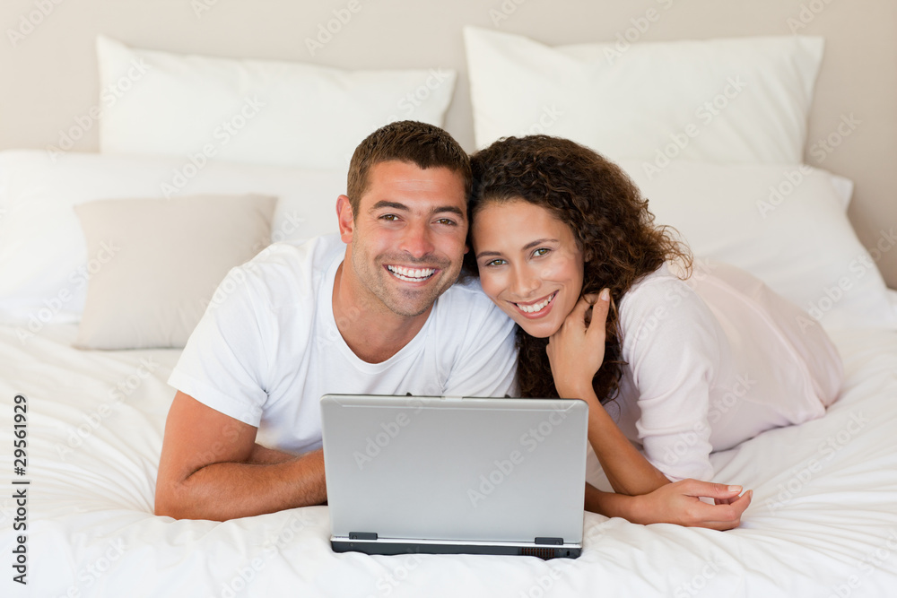 Lovely couple looking at their laptop Lovely couple looking at their laptop