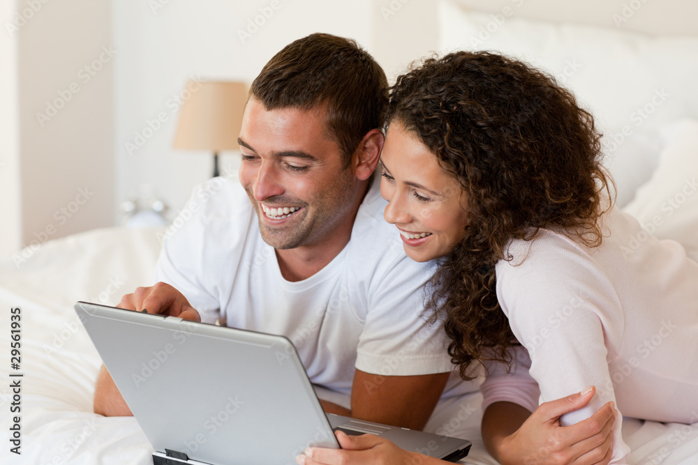Lovely couple looking at their laptop Lovely couple looking at their laptop
