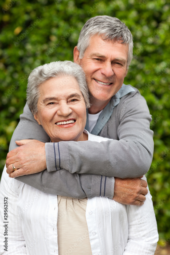 Mature couple hugging in the garden