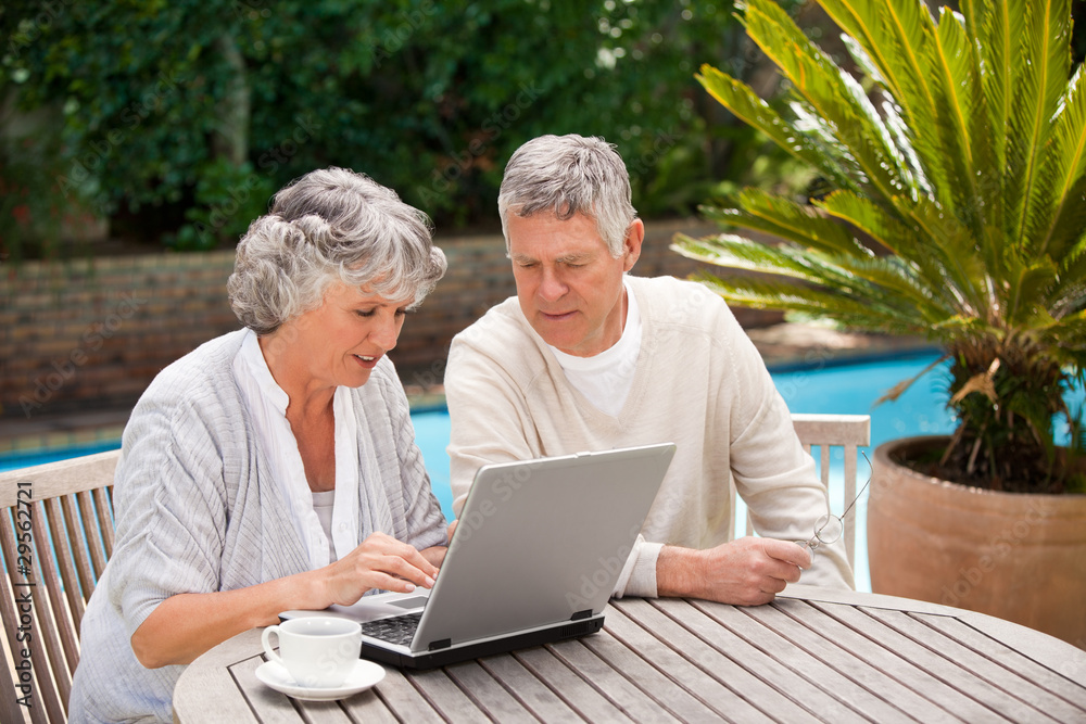 Retired couple working on their laptop Retired couple working on their laptop