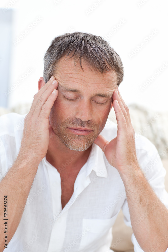 Fototapeta premium Man having a headache at home