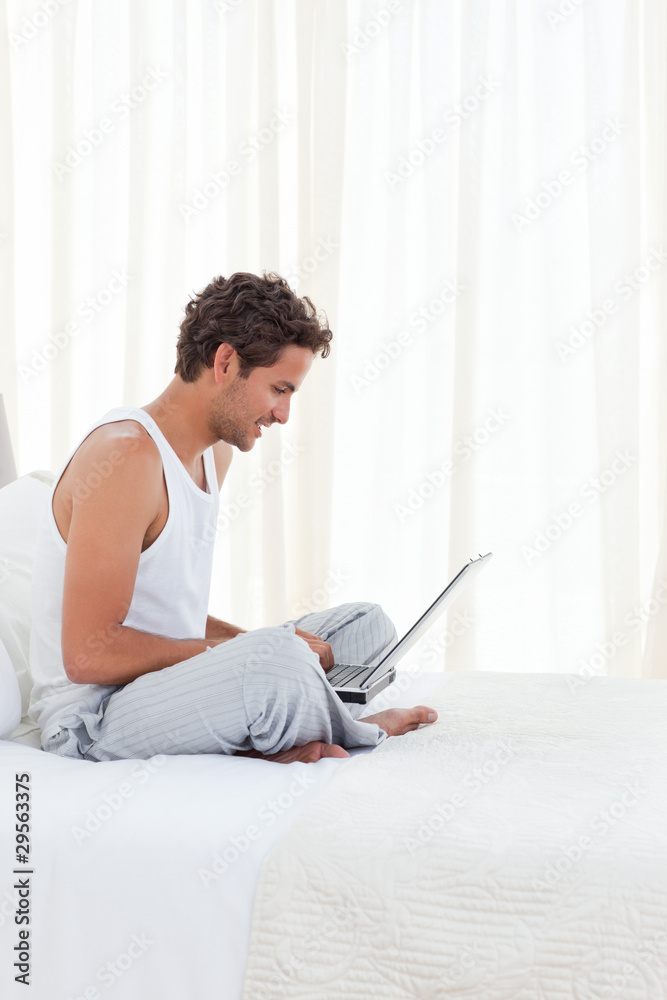 Man working on his laptop at home Man working on his laptop at home