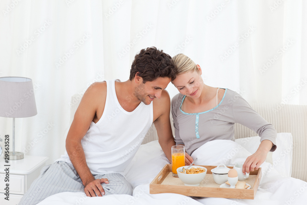 Lovers having breakfast at bed