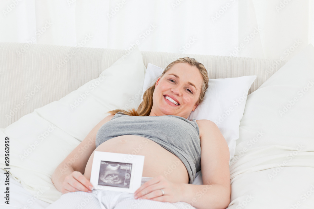 Delighted pregnant woman with her X-ray Delighted pregnant woman with her X-ray