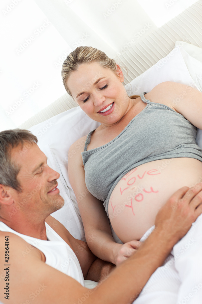 Future father touching his wife's belly Future father touching his wife's belly