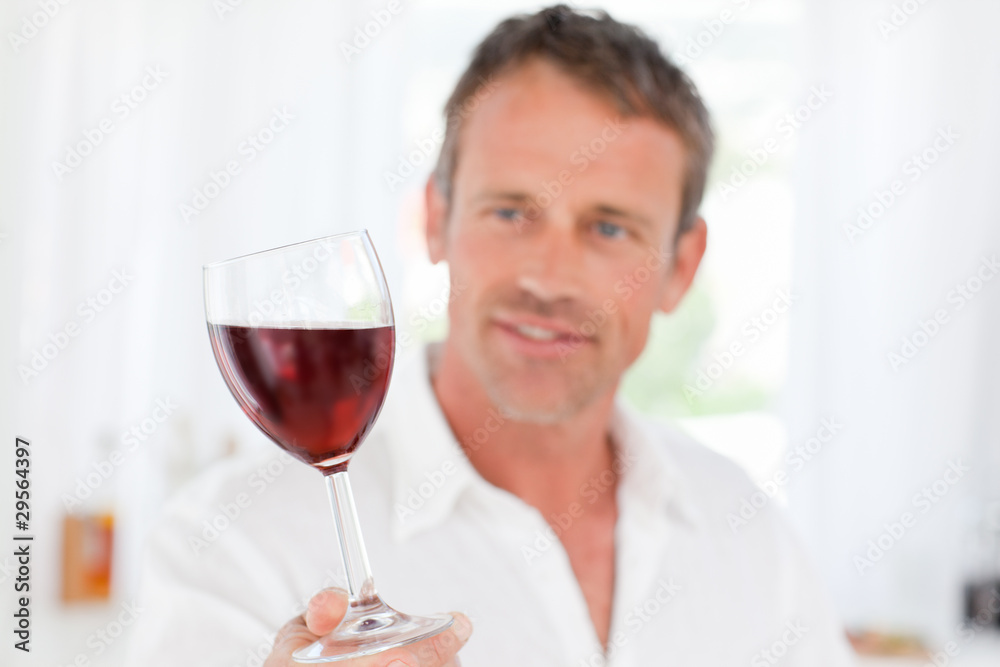 Man with his wineglass in his kitchen Man with his wineglass in his kitchen