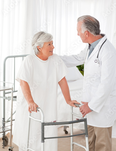 Doctor helping his patient to walk