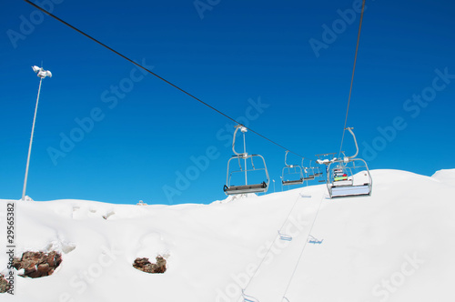 Ski lift chairs on bright winter day