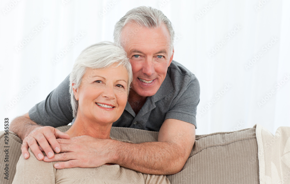 Lovers hugging while they are looking at the camera Lovers hugging while they are looking at the camera