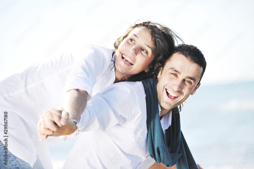 happy young couple have fun at beautiful beach happy young couple have fun at beautiful beach
