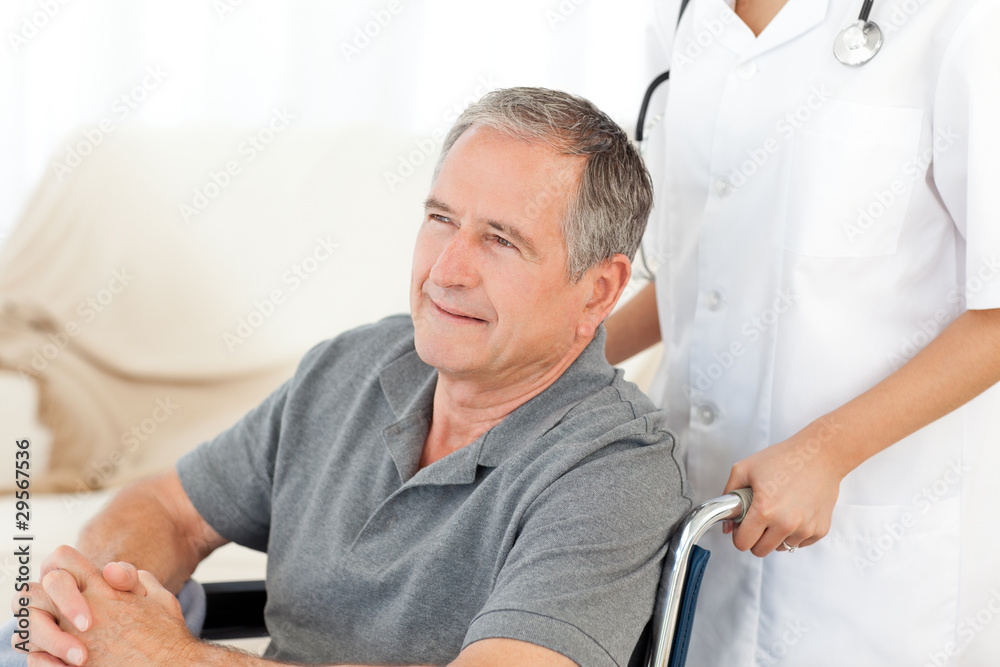 Man in his wheelchair with his nurse at home Man in his wheelchair with his nurse at home