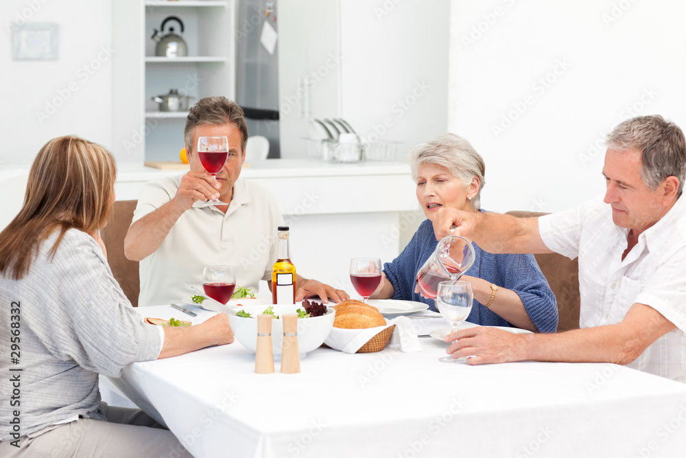 Mature friends taking lunch together Mature friends taking lunch together